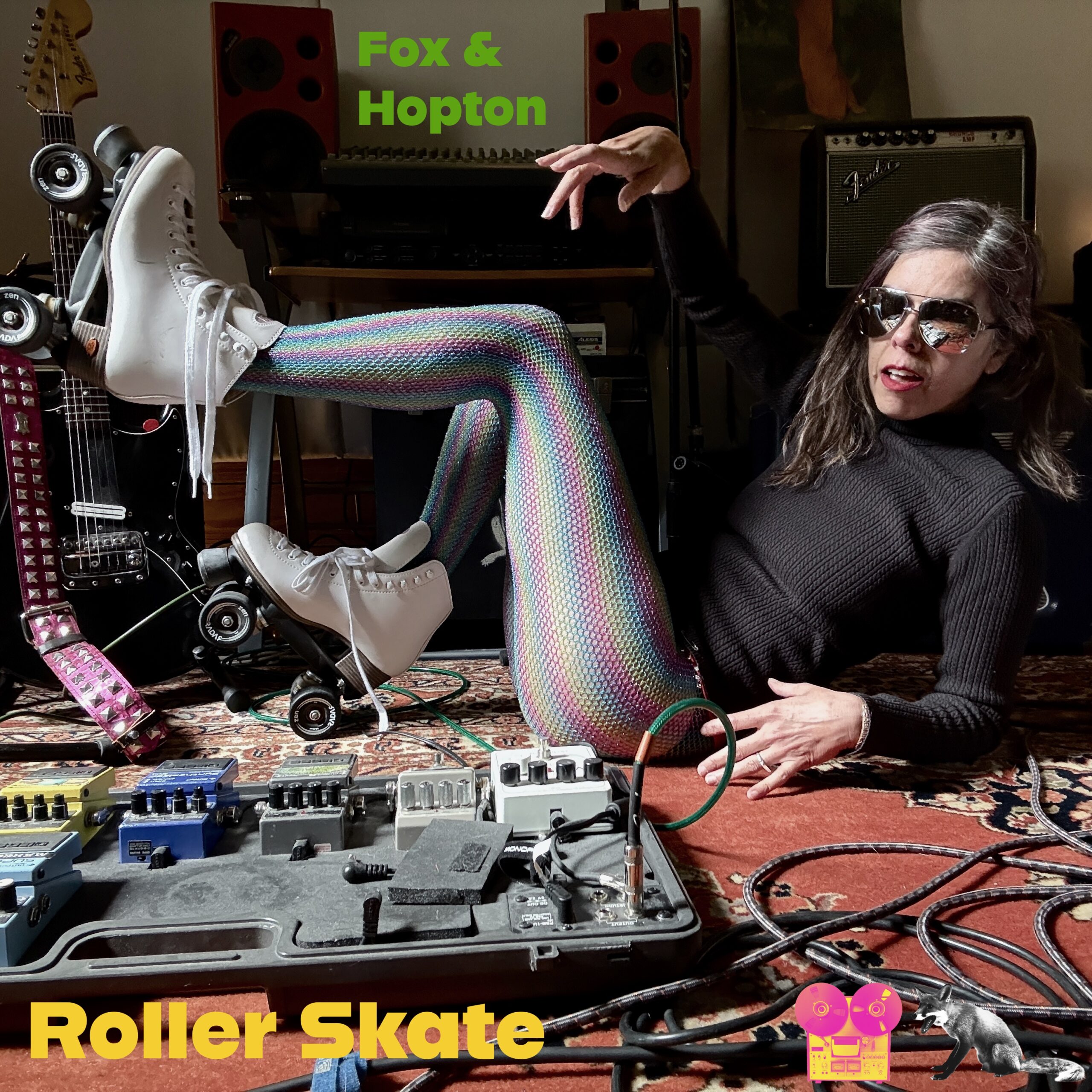 clara belle lying on floor wearing roller skates and mirror glasses